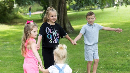 Small group of children holding hands in Ormesby Hall's gardens